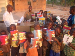 Amanda Lalley distributes books to students outside Lusaka, Zambia.