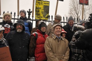 Mark Goldstone '81 (tan raincoat) with anti-war protestors Dec. 16, Daniel Ellsberg to his right