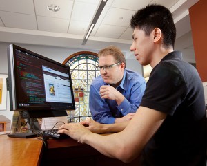 Eric Luhrs, center, head of digital scholarship services, has helped the library develop the infrastructure it needs to support research in the digital humanities. Here he works with Miguel Haruki Yamaguchi '11 on MetaDB, a software program that Luhrs created to allow scholars and librarians to collaborate on the creation of metadata.