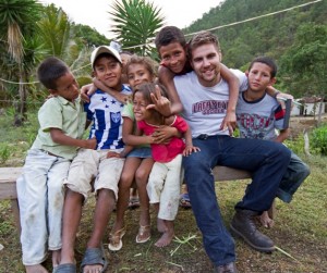 Luke Calvano '12 with children in Honduras