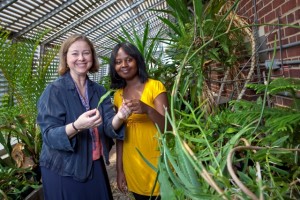 Anna Edlund, assistant professor of biology with and Belinda Sibanda '11 in the greenhouse of Kunkel Hall.