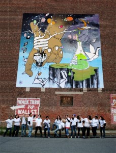 The students in the Community-Based Teaching Program show off their mural.