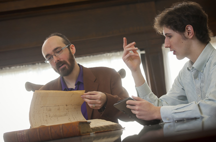 Lafayette College professor Chris Phillips (left) and Gavin Jones '14 examine early circulation records at Easton Public Library.