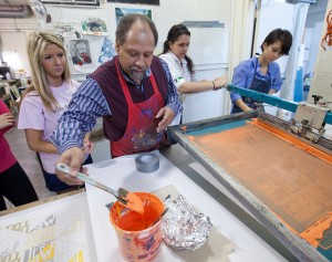 Professor Curlee Raven Holton works with students at the Experimental Printmaking Institute.