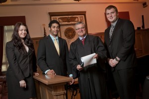 Ruth Dennehy ’12, from left, Julian Delgado ’14, Judge Joel Pisano ’71, and Andrew Anastor ’13 in Pisano’s courtroom in Trenton, N.J.