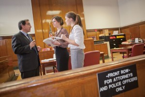 Daniel Rosen P’12 speaks with Megan Devlin ’12 and Elizabeth Moroney ’14 at the New York Supreme Court.