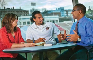 Susan Averett (left), Dana Professor of Economics, Andrew Holmes ’12, and George Bright, associate director of athletics, discuss sports management.