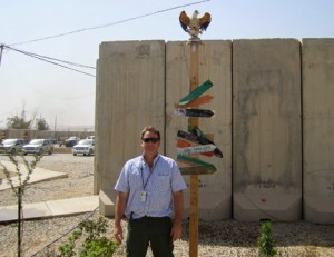 Keith Hanigan '85 stands at a military base in Mosul, Iraq.