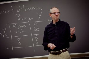 Ed Gamber, David M. '70 and Linda Roth Professor and head of economics, teaches in front of a chalkboard.
