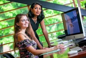 Daniela Filip ’15 and Professor Nandini Sikand edit film in Skillman Library.