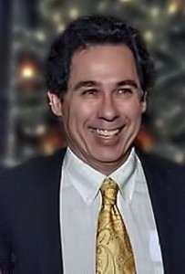 Jeffrey Fry '81 wearing a suit with a yellow tie