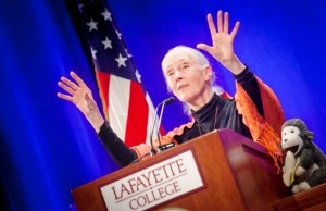 Hands raised for emphasis, Jane Goodall speaks at a podium in Lafayette's Kamine Gym.