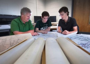 Roger Ruggles, associate professor of civil and environmental engineering, looks over plans of Easton's sewer system with Matthew Muller ’14 and Samuel Brinton ’14.