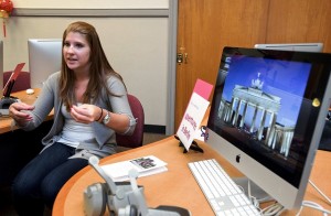 Nicole Dieterich '13 sits and discusses her experiences in Germany by a desk with a computer