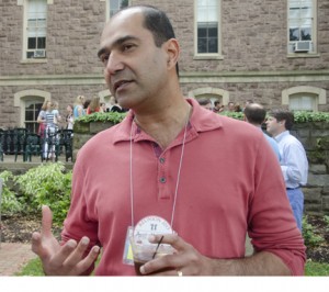 Amit Mohindra '88 holds a baseball and talks