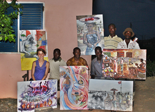 Lindsay Majno '10 with artists who participated in the Ghana project pose with paintings.