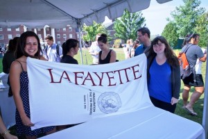Students pick up their commemorative inauguration beach towel during the dessert social in Anderson Courtyard. 