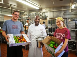 Peter Todaro '16 and Julia Kripas '15 deliver the produce to Michael Wedderburn, executive chef in Dining Services.