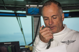 Capt. S. Robert Roth '81 on his ship speaking through a communication device