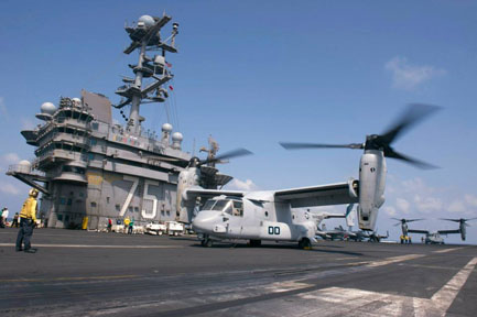 USS Harry S. Truman with aircraft and military personnel on deck