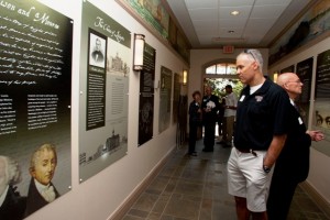 Carl St. Bernard '86 reads wall panels at the exhibit opening in Pardee Hall.