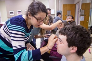 Makeup is applied to students in the Making Theater On Aging course to simulate the aging process. 