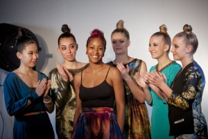 Terese Brown ’07, surrounded by applauding student models and wearing a silk hurricane skirt that marries art with couture