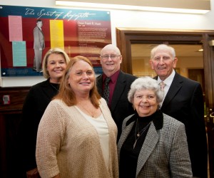 Frank Hunt’s grandchildren – Sara Lewis, Ruthanne Lewis Turcotte, and Larry Lewis – with Sandye Turnauer and Jerry Turnauer '59 in front of the plaque dedicated to Dean Hunt in Hogg Hall