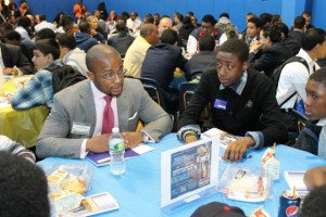 Nkrumah Pierre ’06 speaks with students during a workshop at Monroe College in New York City.
