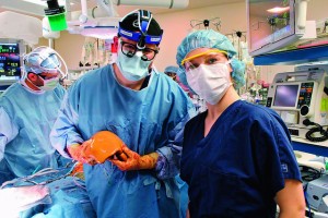 Dr. Kenneth Chavin ’83 P’16 describes the transplant procedure and liver characteristics with Emily Oliver ’17 in the Medical University of South Carolina operating room.