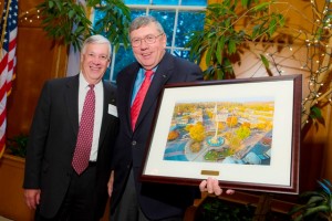 Edward Ahart ’69, left, chair of the Board of Trustees, presents a painting to trustee Carl Anderson ’67 for serving as chair of the Easton Committee since 2003.