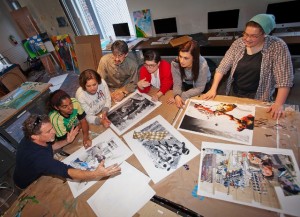 Jim Toia, left, director of the College’s Community Arts Program, discusses design concepts with members of the team.