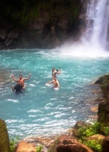 Three Lafayette students enjoy aqua blue water near a waterfall in Costa Rica.
