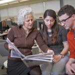 Jeanne Straus P’13, Cassidy Taylor ’17 and Adam Valavanis ’17 peruse one of Straus News’ 14 publications.