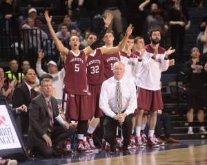 Lafayette players on the bench cheer as they and head coach Fran O'Hanlon watch the action against Bucknell