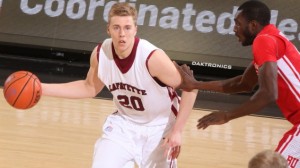 Men's basketball player Dan Trist dribbles the ball while defended by a Boston University player