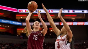 Women's basketball player Emily Homan '15 shoots the ball with a Louisville defender covering her.