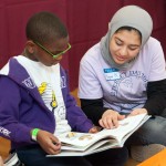 Hagar Kenway ’17 helps a student with the book.