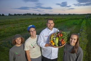 John Soder, executive chef of dining services, holds some of the LaFarm produce that will be used in the College dining halls. 