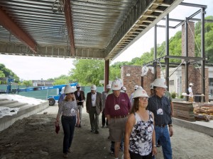Alumni take a guided hard hat tour of the future Black Box Theater in the Williams Arts Campus.