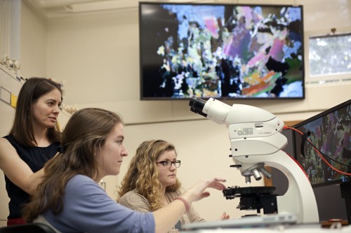 Professor Tamara Carley assists Annika Leiby '18 and Lissie Connors '18 with identifying a sample using the new microscopes in Van Wickle Hall.