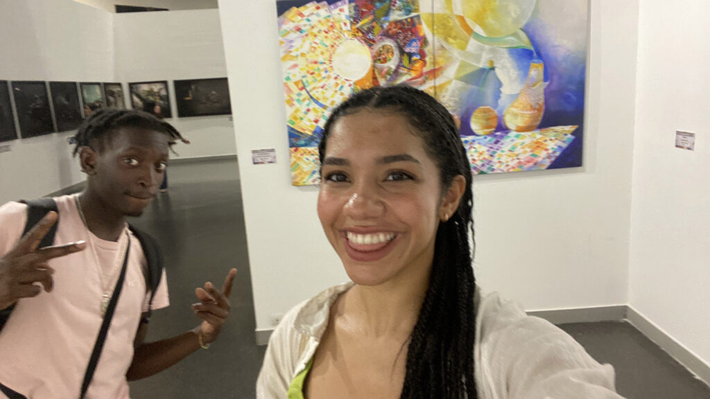 Eline Pellicano ’24 smiles in front of art.