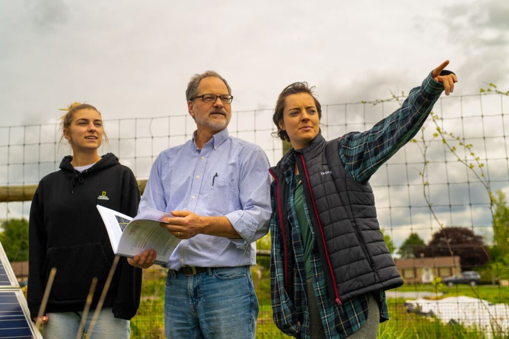 Olivia Zoretic ’24, Prof. David Brandes, and Rachel Hurley ’23 review carbon reduction plan at Metzgar Fields 