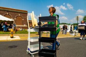 A Lafayette volunteer pushes two carts during the 2023 West Ward Sale