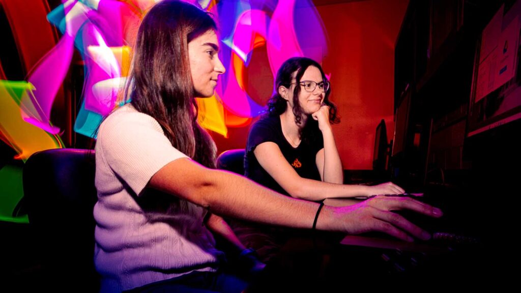 Lafayette students Rose Broderick and Ricki Blaustein conducting research on a computer in a lab