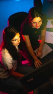 Lafayette students Rose Broderick and Ricki Blaustein conducting research on a computer in a lab