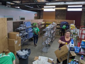 Volunteers unpack boxes of food donations and fill the shelves at the Salvation Army's food bank.