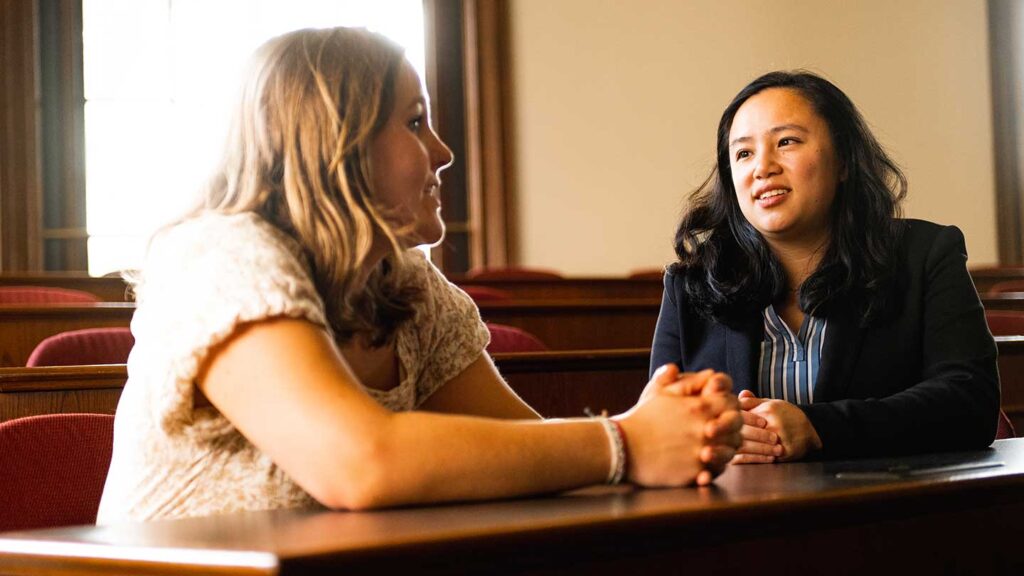 Prof. Stephanie Chan and Lafayette student Ella Dalgliesh sitting in a classroom and talking to each other