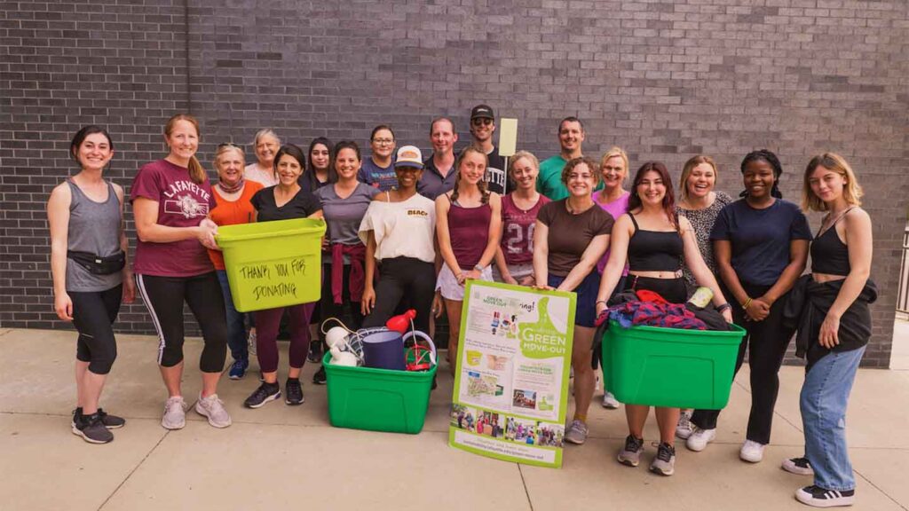 Lafayette staff, faculty, and students are pictured holding tubs of donations during Green Move Out