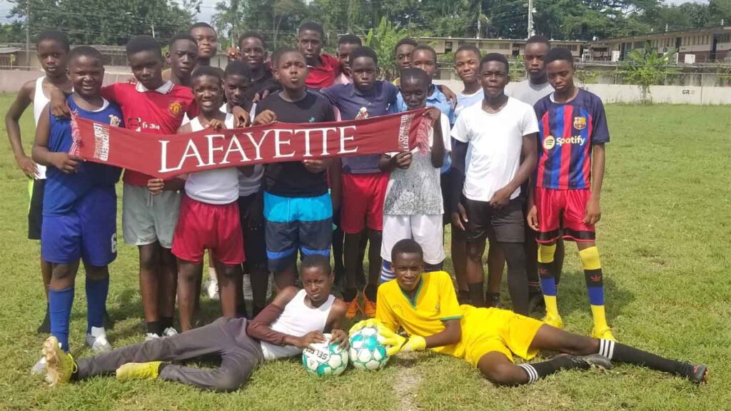 Andrey McIntyre is pictured with his high school soccer team in Jamaica, holding up a Lafayette banner